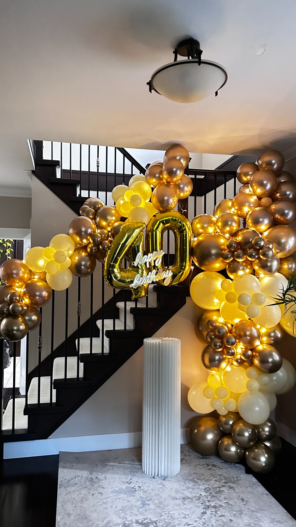 Illuminated gold fortieth birthday balloon arch